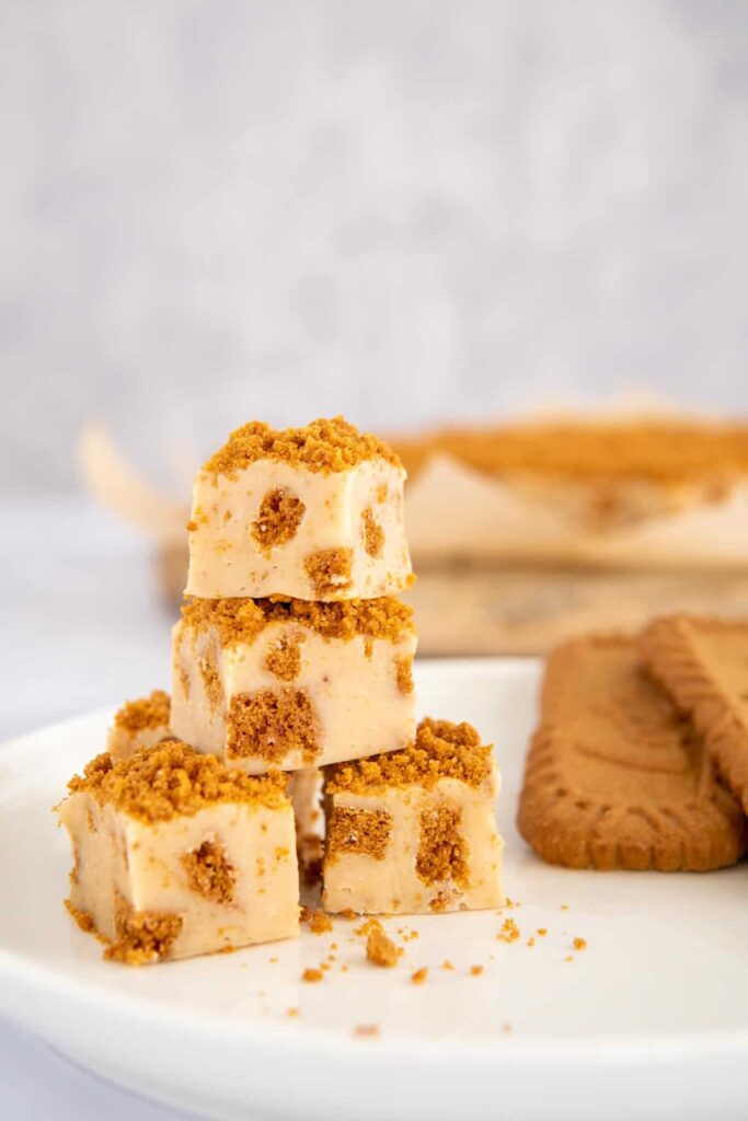 Bixcoff fudge stacked with biscoff cookies in the background.