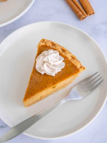 A slice of pumpkin pie made with this easy pumpkin pie recipe without evaporated milk.