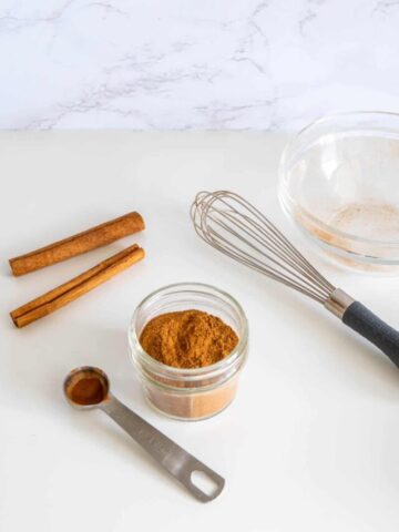 Mixed homemade pumpkin pie spice mix in a bowl with a whisk.