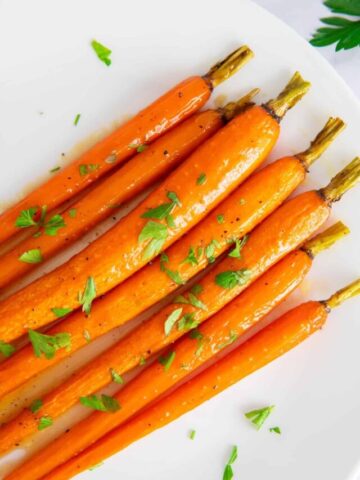 Close up shot of maple glazed carrots with brown sugar.