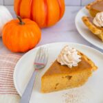 A slice of pumpkin pie made with this easy pumpkin pie recipe without evaporated milk.