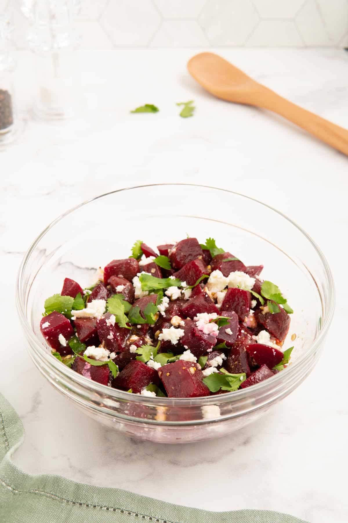 Beetroot, feta, and parsley in a glass bowl.