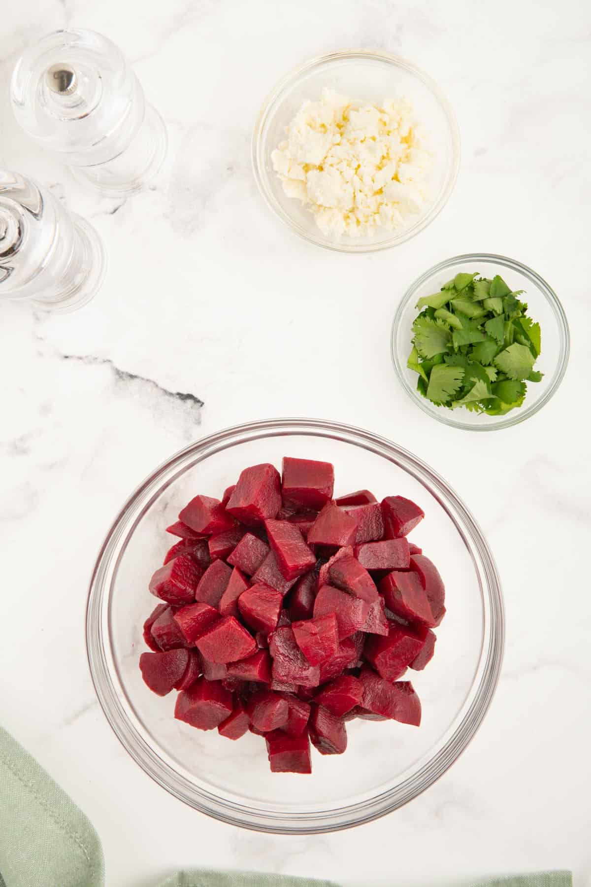 Beetroot, parsley, and feta in separate glass bowls.