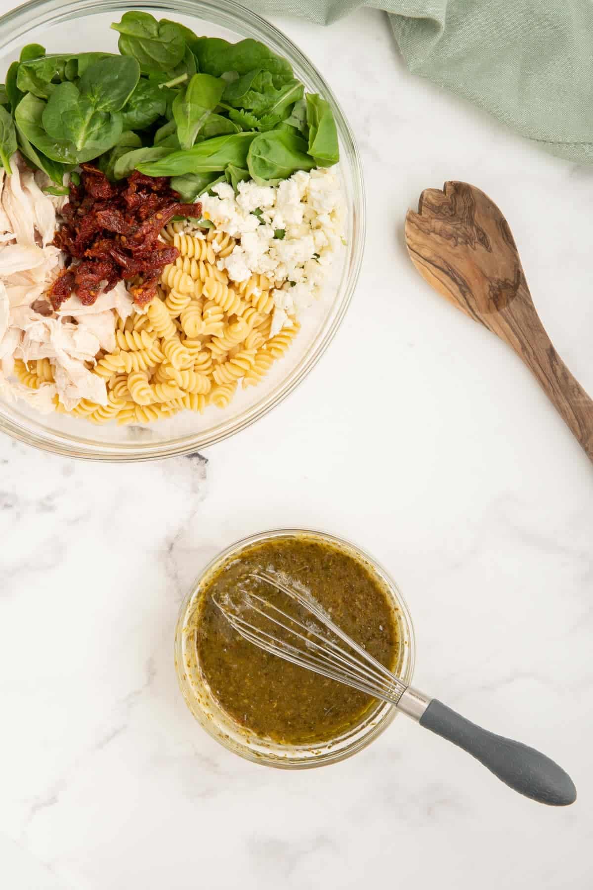 Pesto and Italian dressing mixed together to make the dressing for chicken pesto pasta salad.