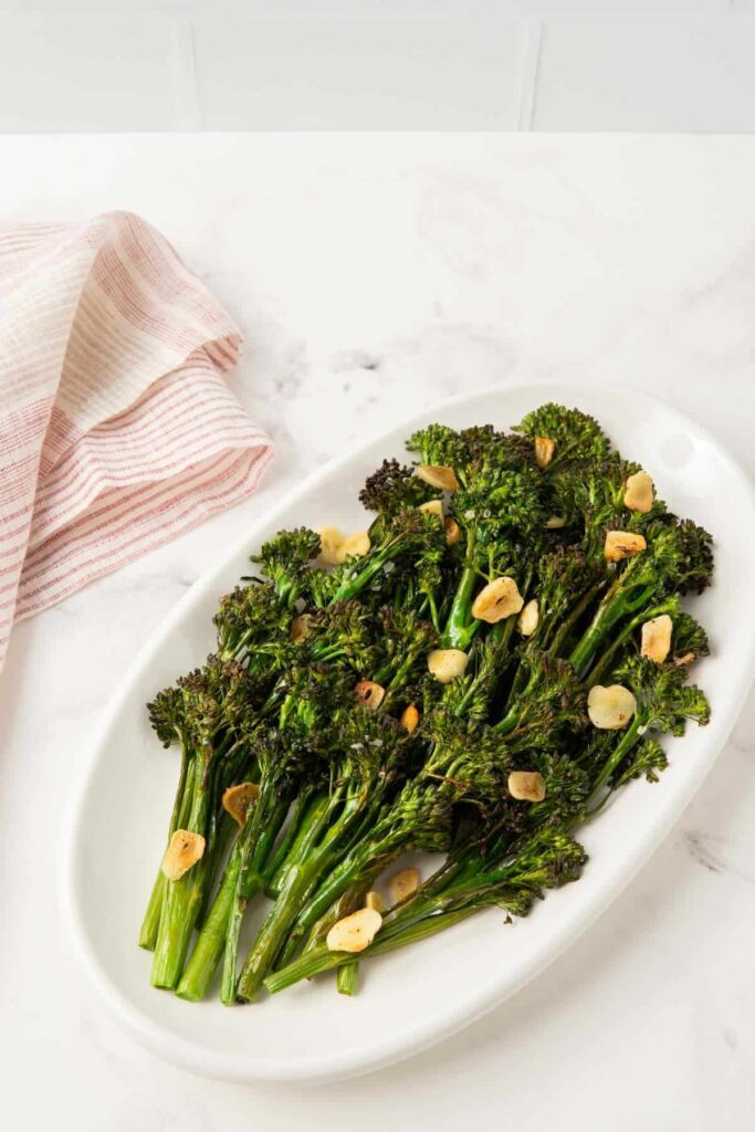 Roasted tenderstem broccoli on a white platter.