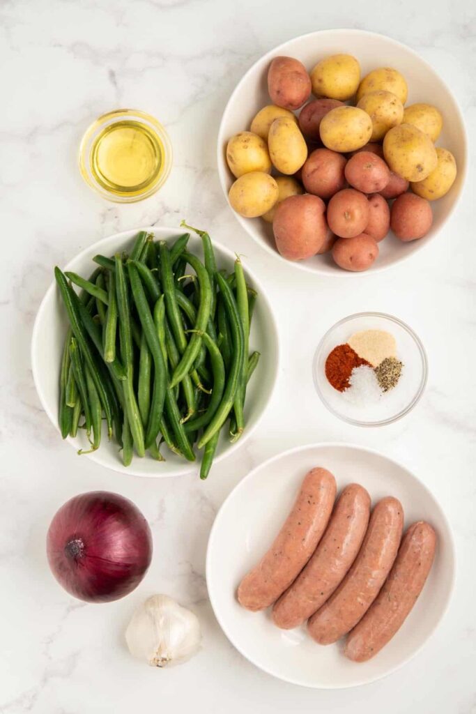 Ingredients needed to make sausage green bean potato casserole.