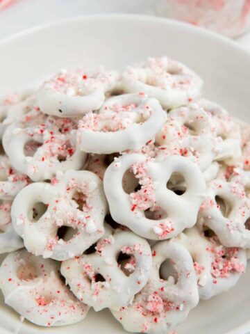 A close-up shot of candy coated Christmas pretzels with crushed candy canes.