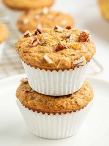 A stack of two Kodiak Cakes muffins in white paper liners.