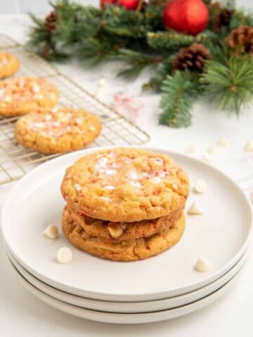 A stack of three white chocolate and peppermint cookies with white choc chips.