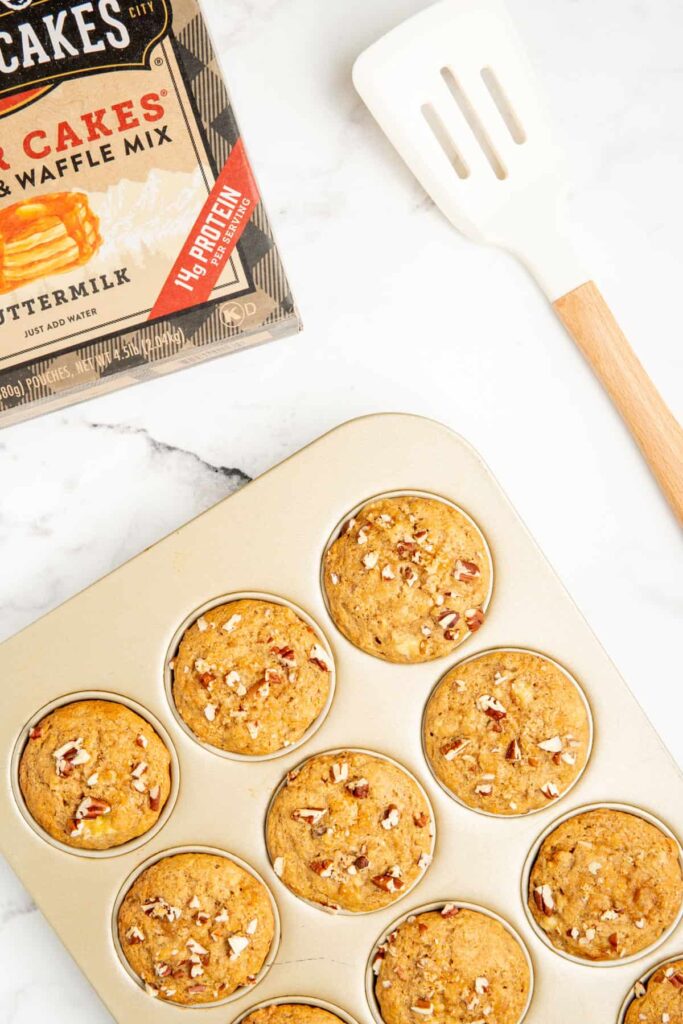 Cooked banana nut Kodiak Cakes muffins in a muffin tin.