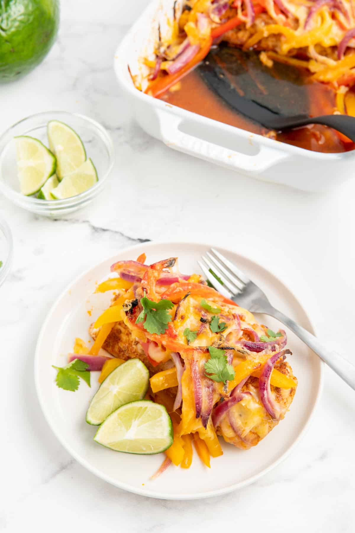 Low carb chicken fajita casserole served on a white plate with a fork.