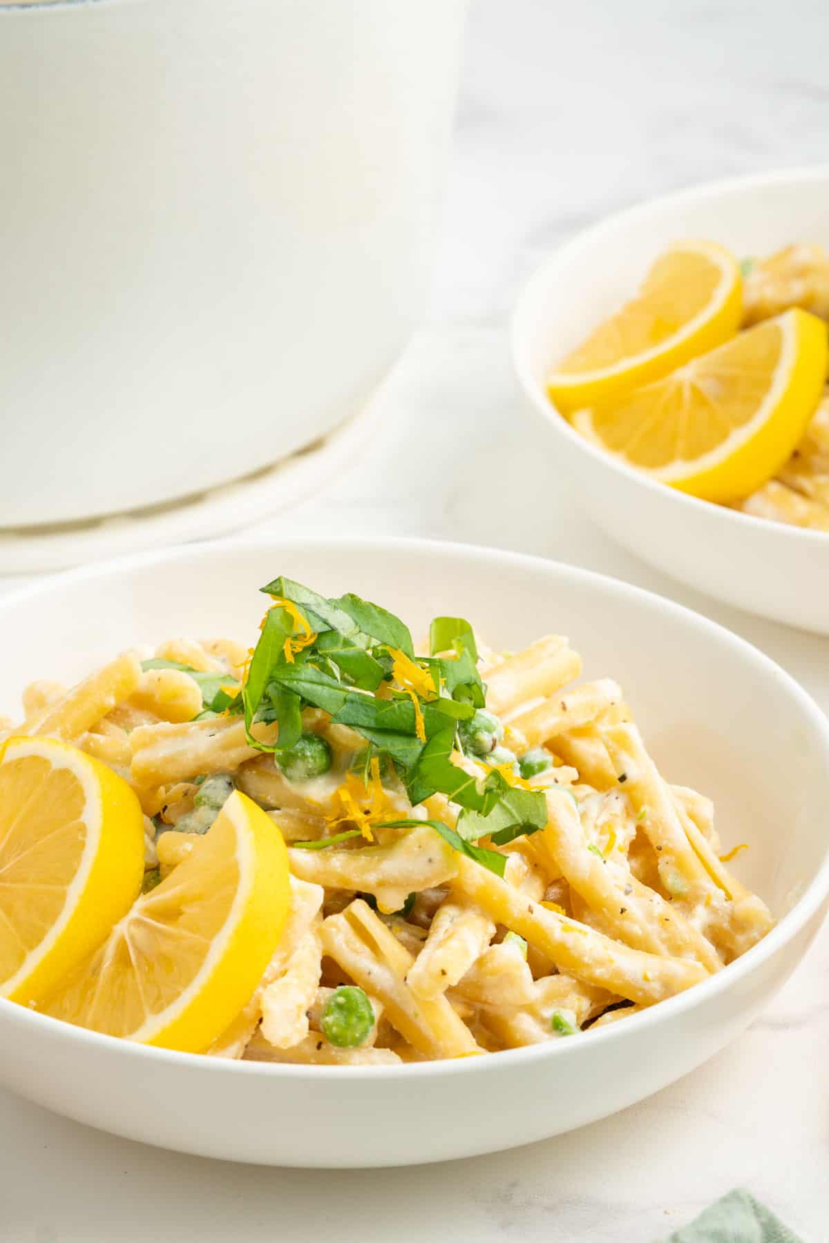 A close-up shot of a bowl of one pot pasta with ricotta and lemon.