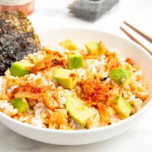 TikTok salmon and rice bowl served with sheets of nori, avocado, and kimchi.