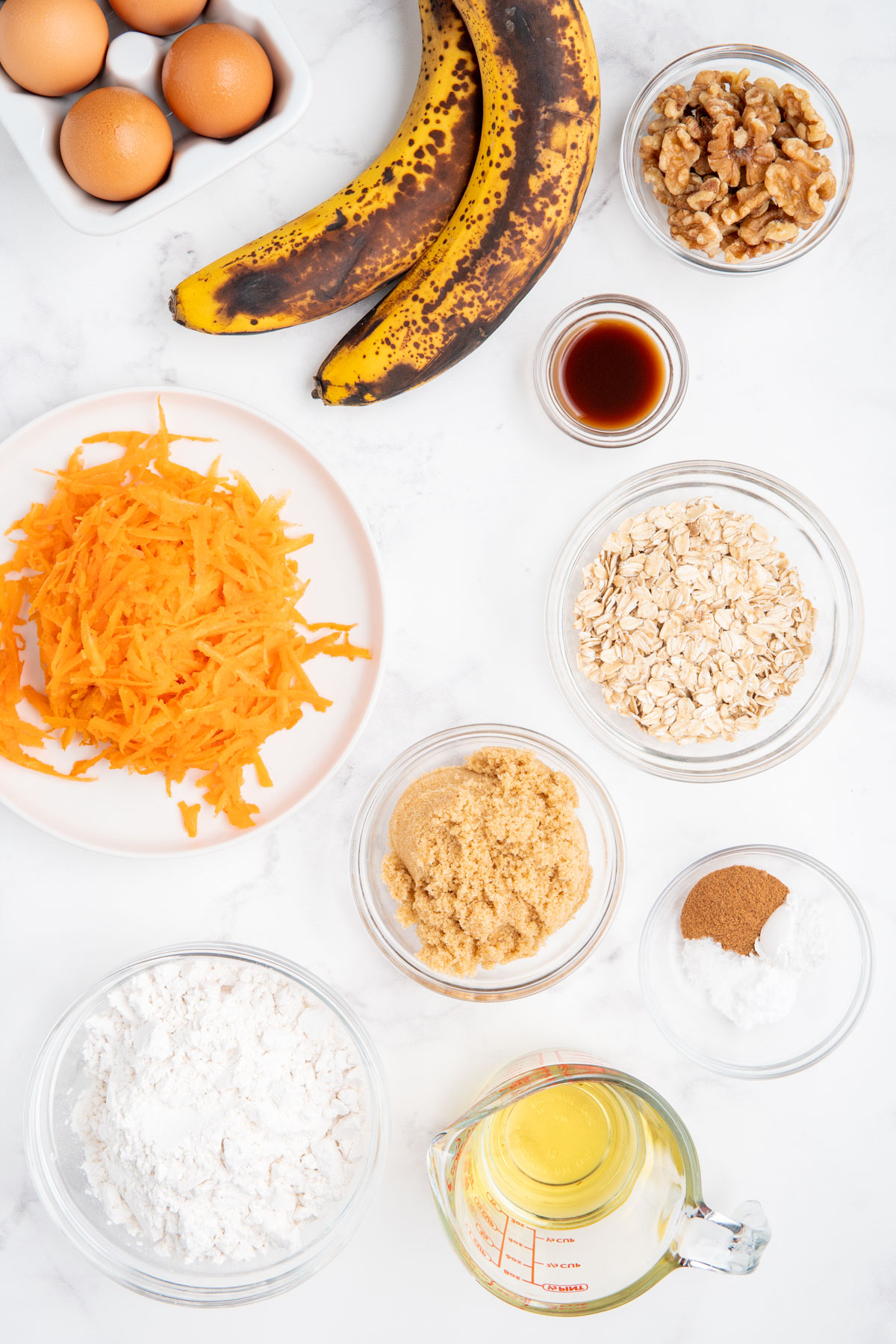 Ingredients needed to make carrot banana muffins with oats.