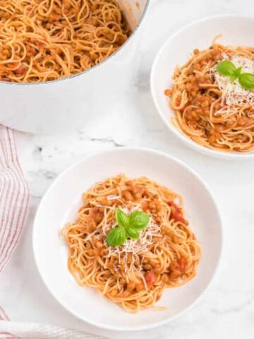 Two bowls of 3 ingredient creamy tomato lentil pasta.