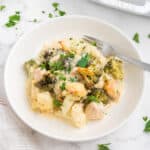 Keto chicken alfredo casserole served in a white bowl and topped with parsley.