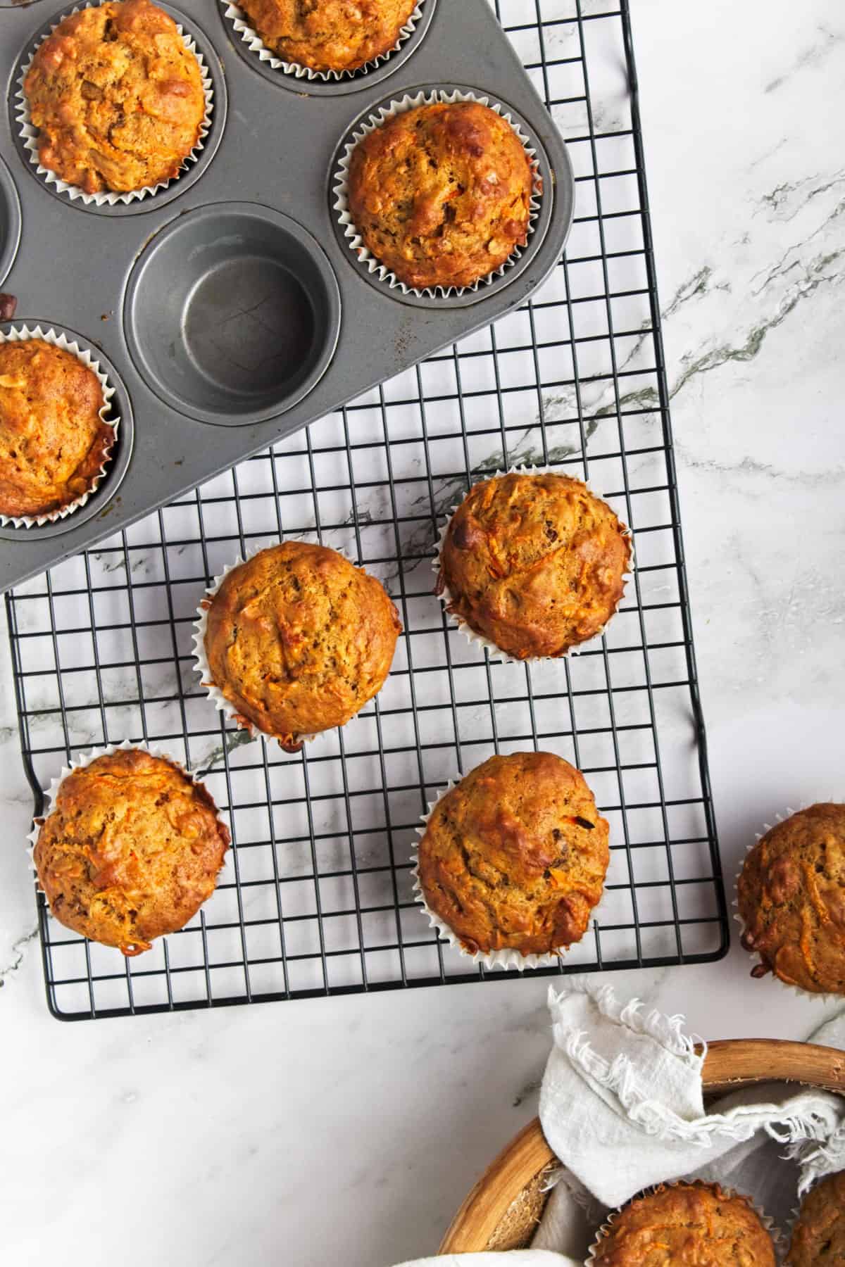 Oatmeal carrot muffins on a wire rack.