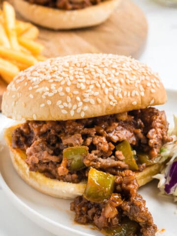 An old fashioned sloppy joe sandwich with french fries and coleslaw.