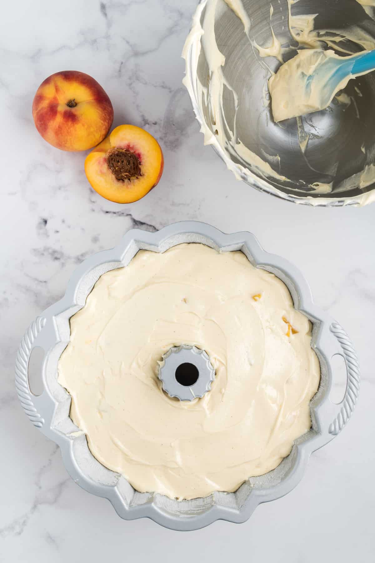 Peach cobbler pound cake batter in a bundt pan.
