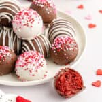 Red velvet cake balls stacked on a plate.