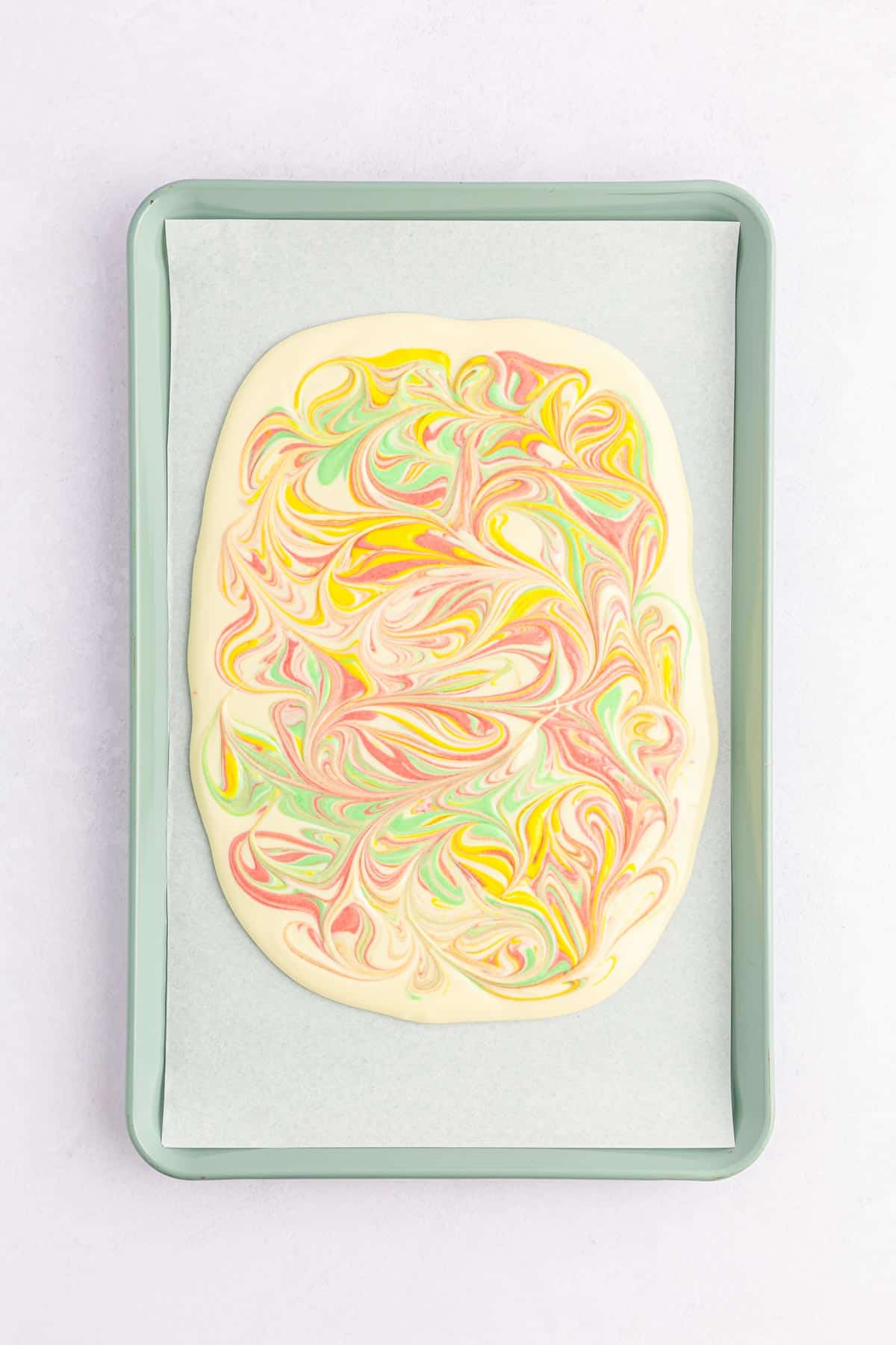 Red, yellow, and green colored white chocolate swirled through a white chocolate base for Easter bark.