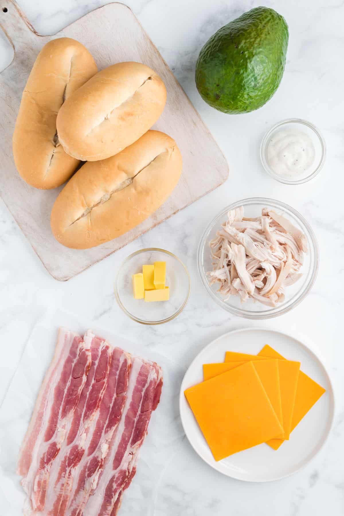 Ingredients needed to make a chicken bacon ranch sandwich.