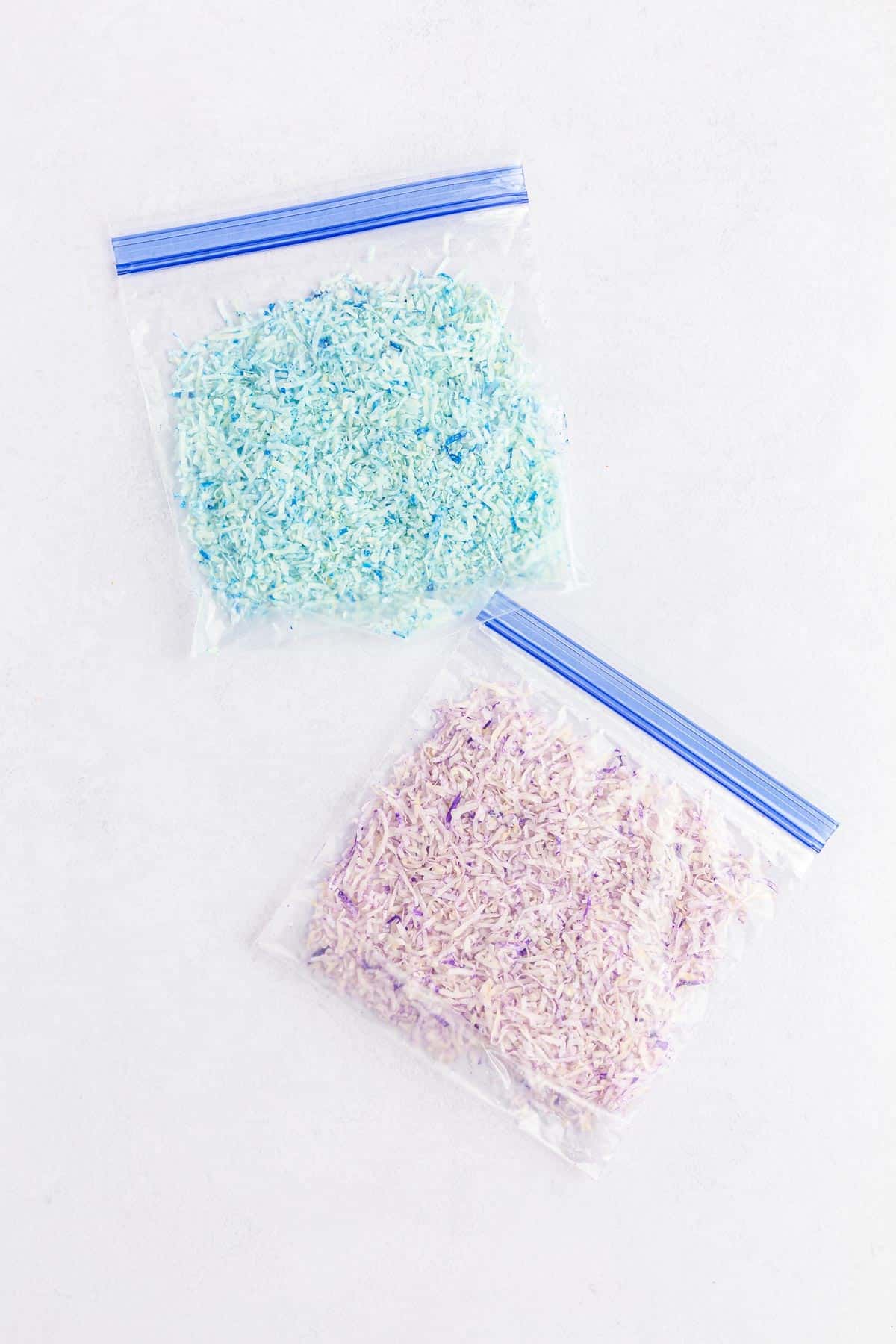 Blue and purple shredded coconut in ziploc bags.