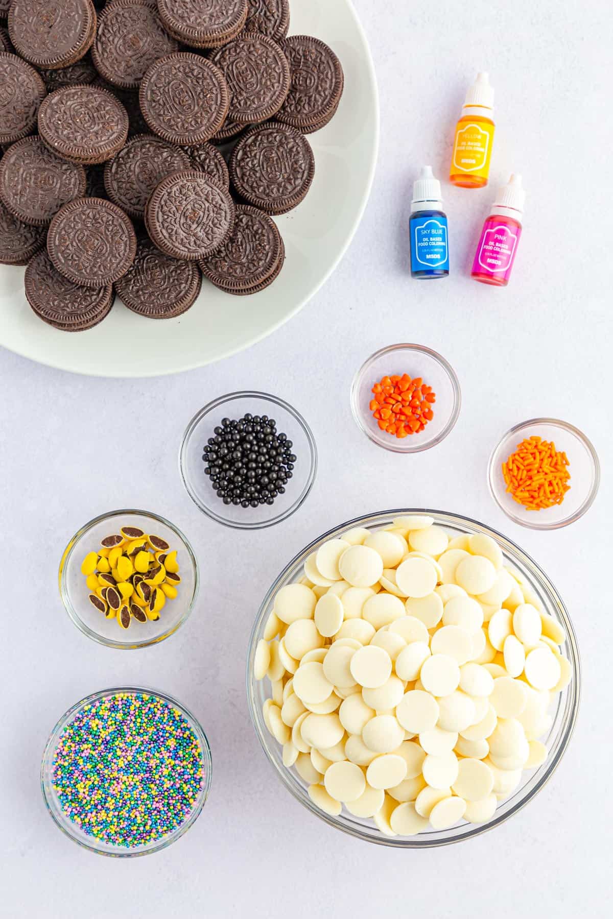 Ingredients needed to make chicks and eggs themed easter chocolate covered oreos.