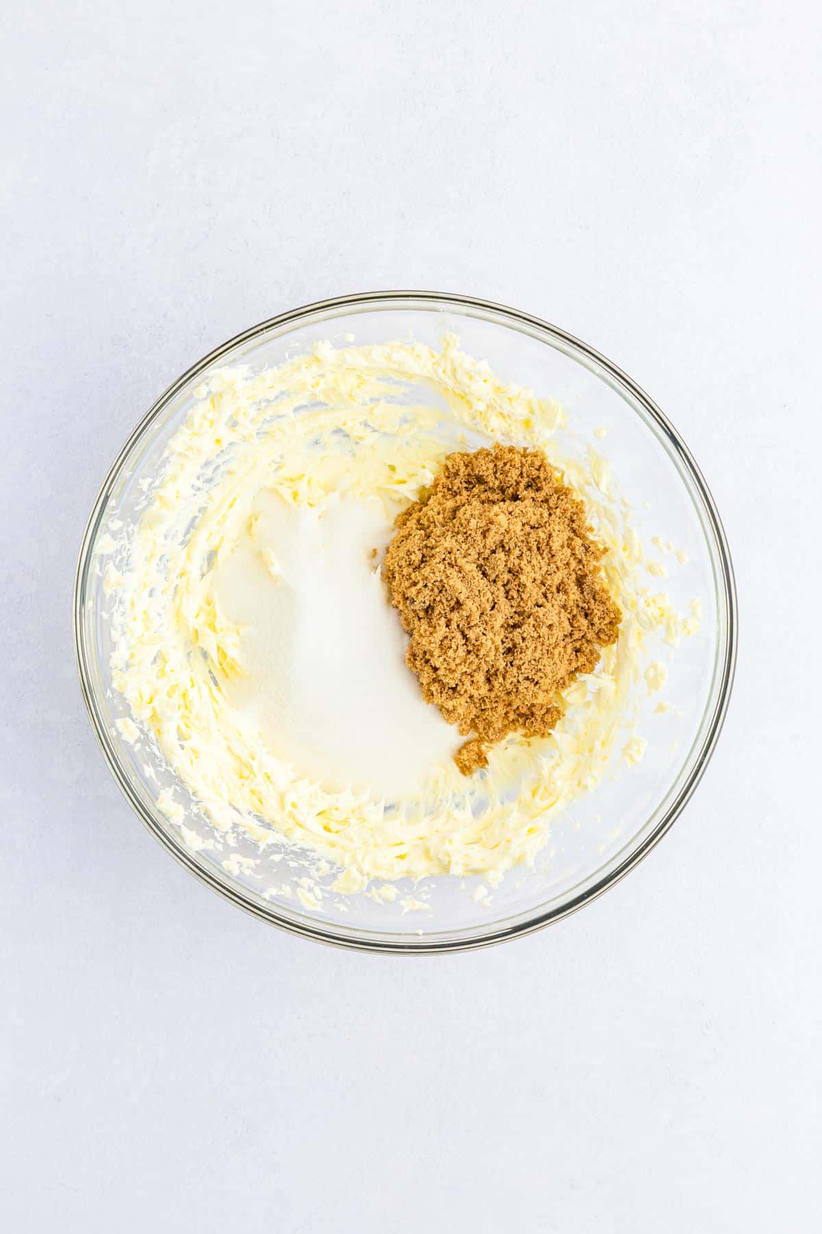 Butter and sugars creamed together in a bowl.