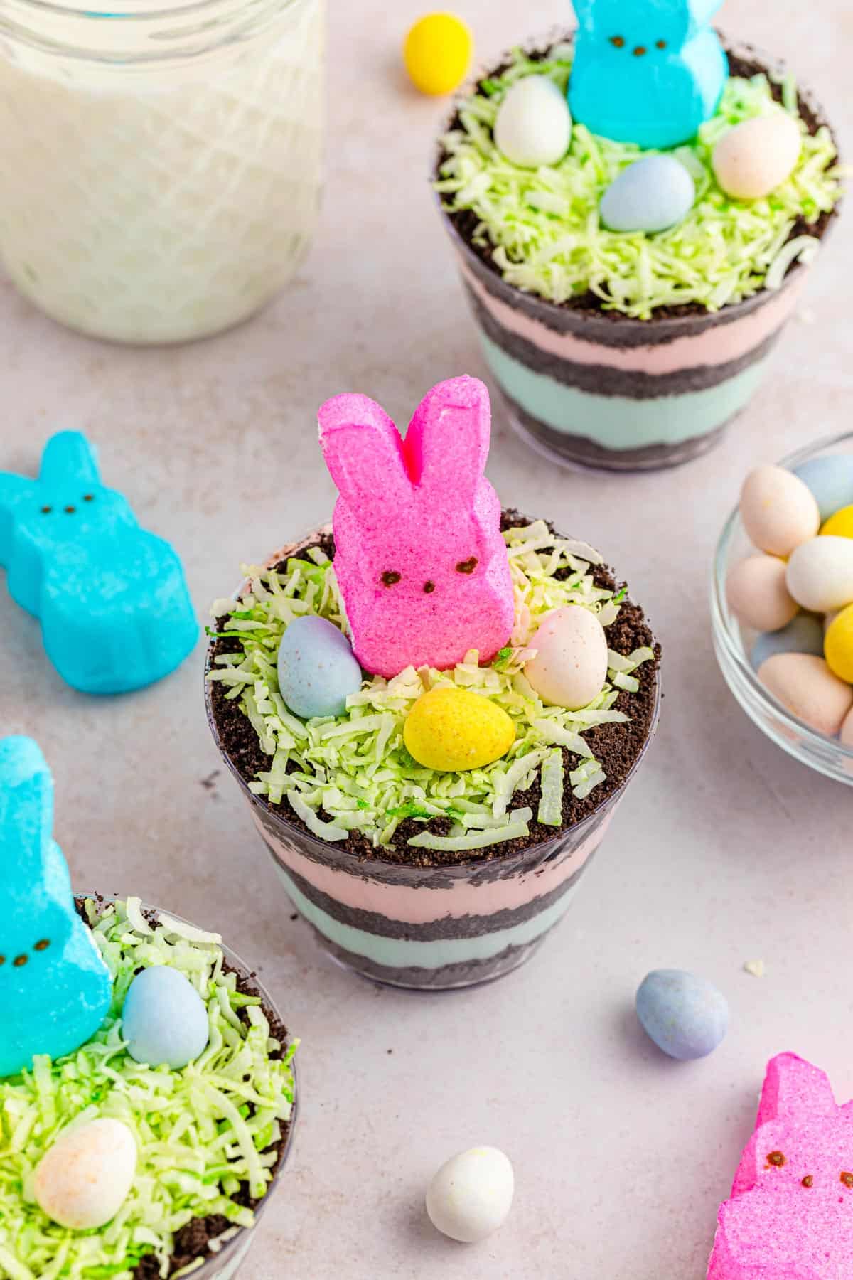 Peeps easter dirt pudding cups topped with coconut grass and Cadbury mini eggs.