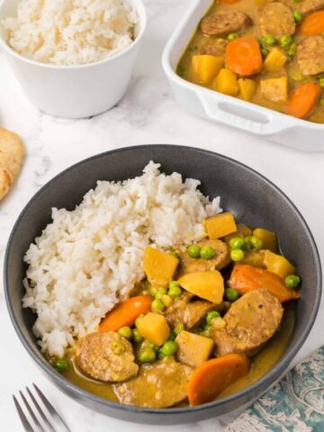Slow cooker curried sausages with a side of white rice.