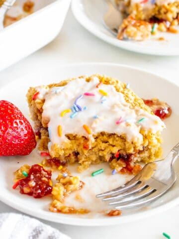 Strawberry pop tart baked oats served on a white plate.