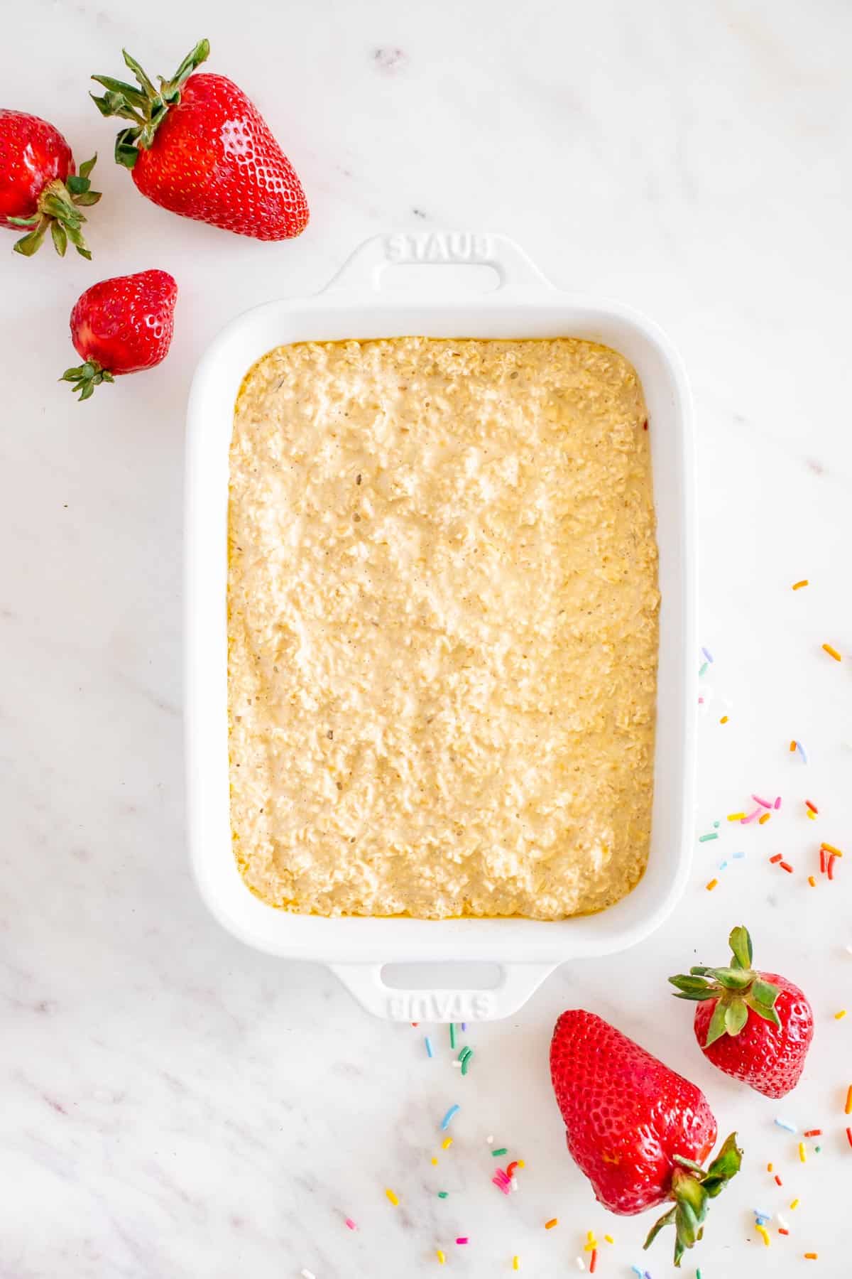 Adding a second layer of batter to make strawberry pop tart baked oats.