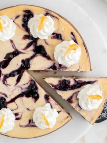 Overhead of a slice of lemon blueberry cheesecake.
