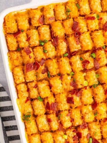 Easy cheesy chicken tater tot casserole in a white casserole dish.