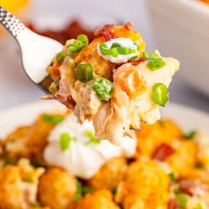 A forkful of easy cheesy chicken tater tot casserole.