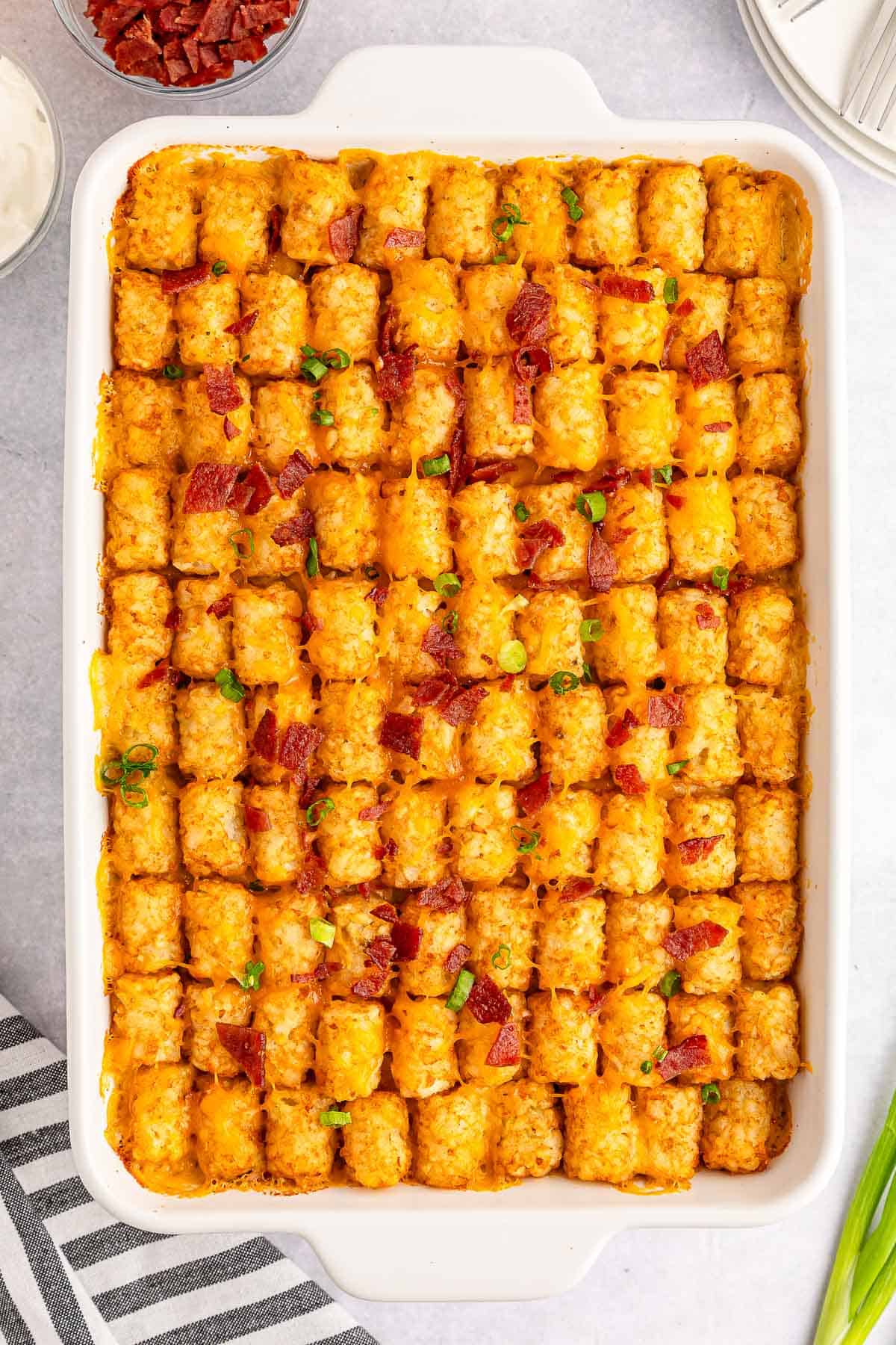 Easy cheesy chicken tater tot casserole in a white baking dish.