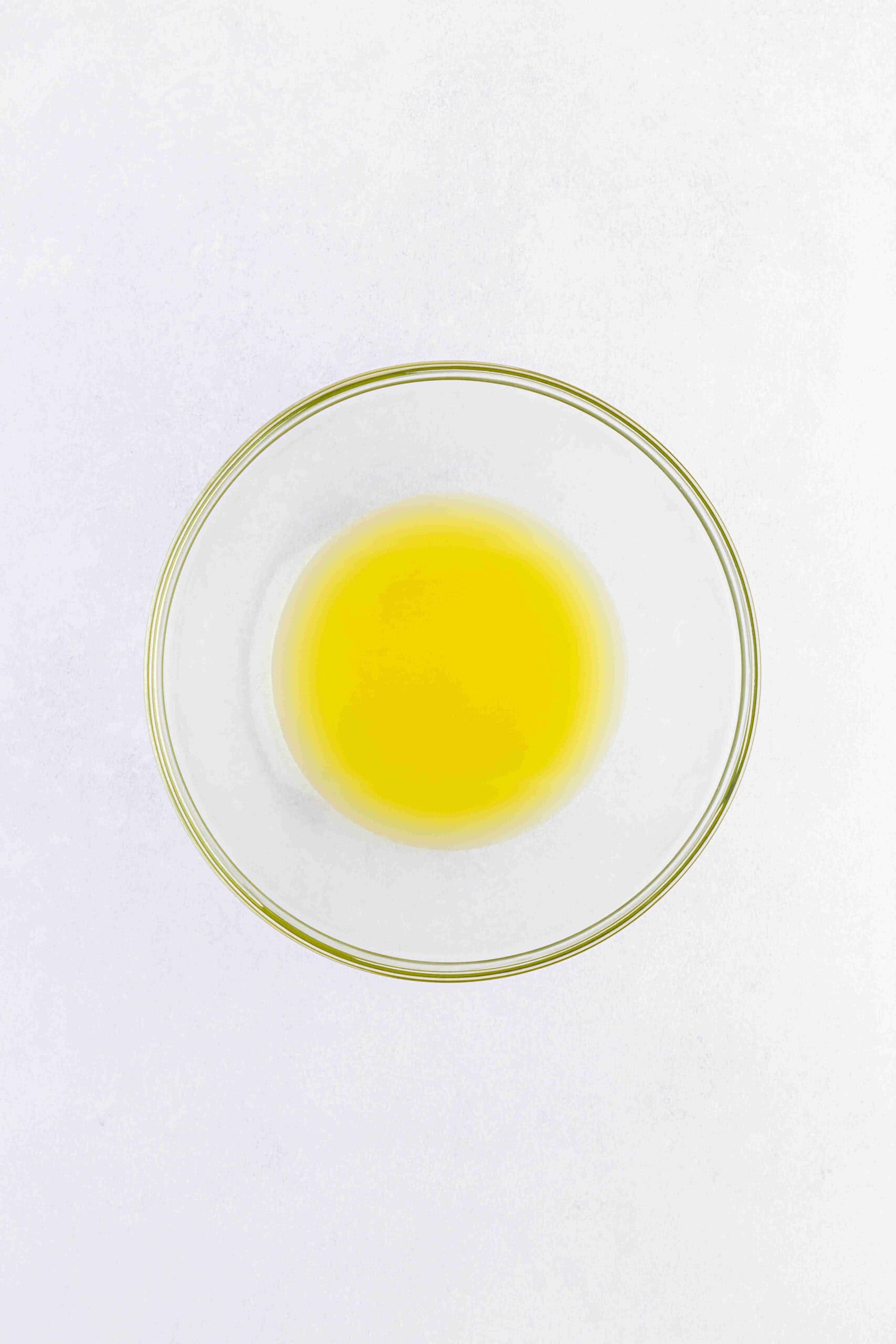 Pineapple juice in a glass mixing bowl.